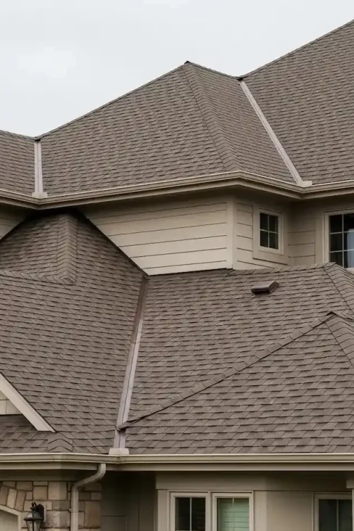 Corner view of two story suburban home with mixed brown and charcoal architectural shingle roof installed by Katy TX roofing contractors